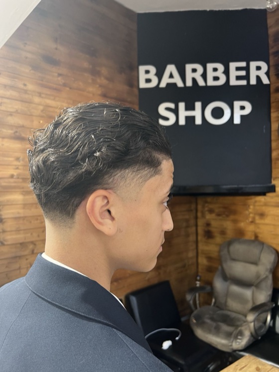 Curly top with a clean taper