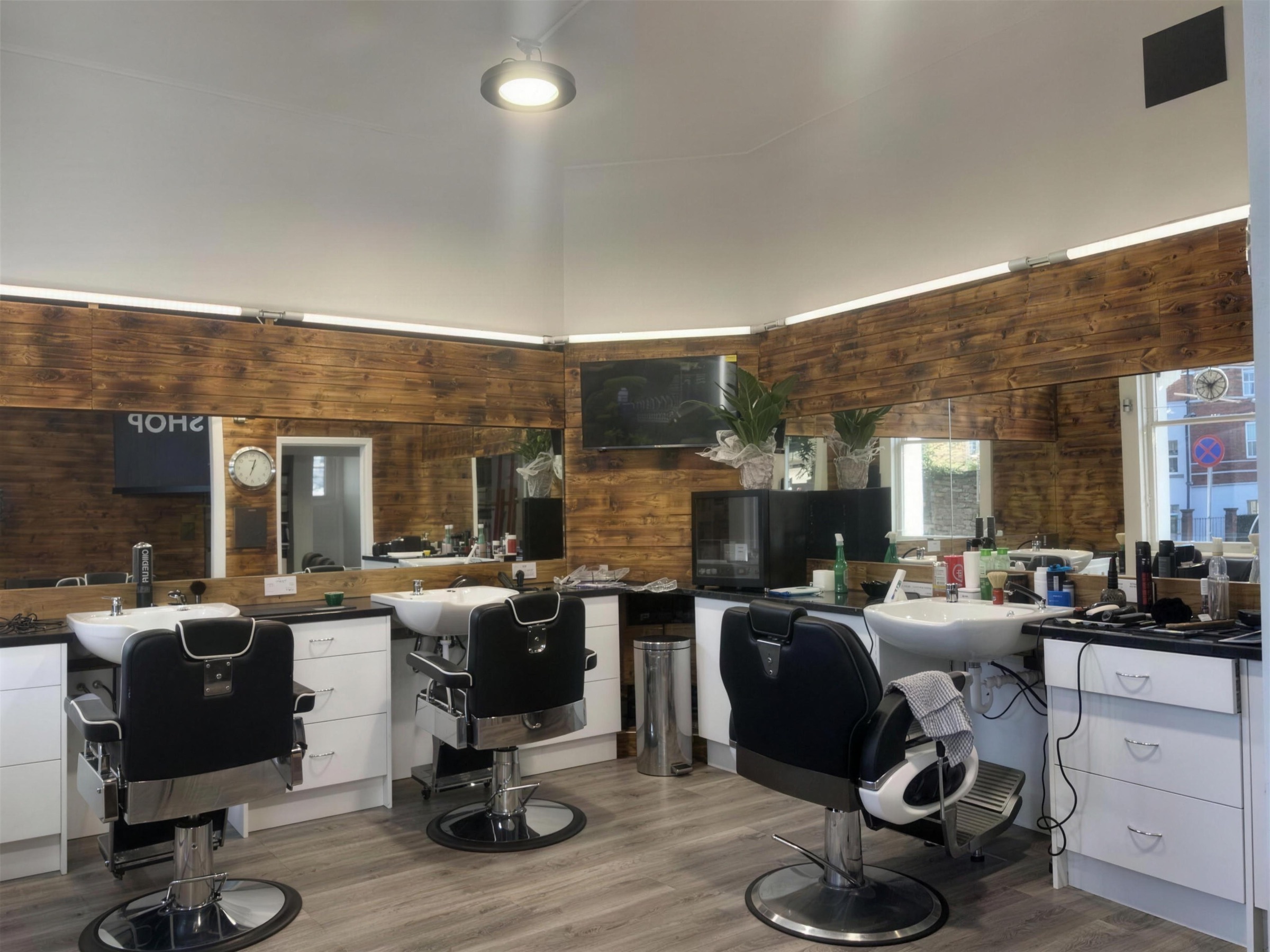 Inside Style Barbers — wood-panelled walls, mirrors and barber chairs
